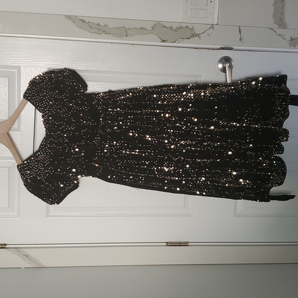 HOLIDAY! Black and gold dress for girls, has gold sequins that shimmer.